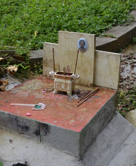 A Christian Woman's grave. Her memory is honoured with joss sticks
