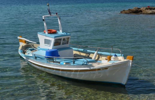 Blue Aegean, wooden boats, white houses, red wine